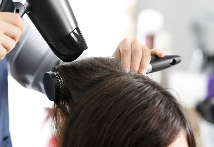 a girl getting a blowout at Garbo's salon and spa