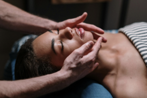 Picture of a very relaxed massage client and the hands of the Professional Masseuse at Garbo's Salon and Spa