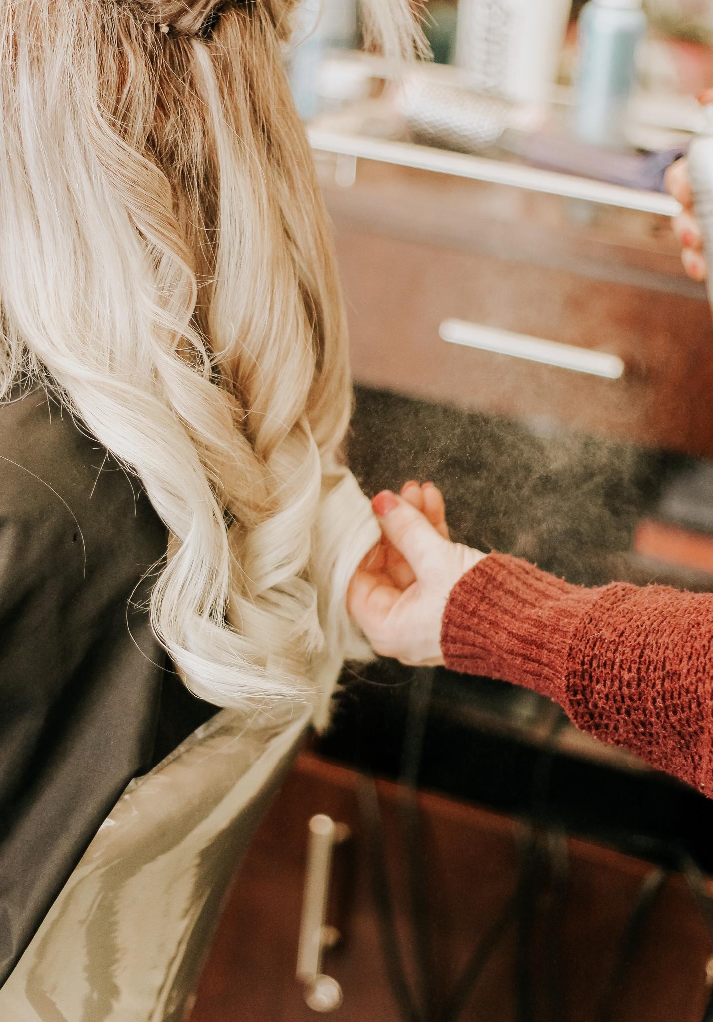 A curled hair style for a long blond hair