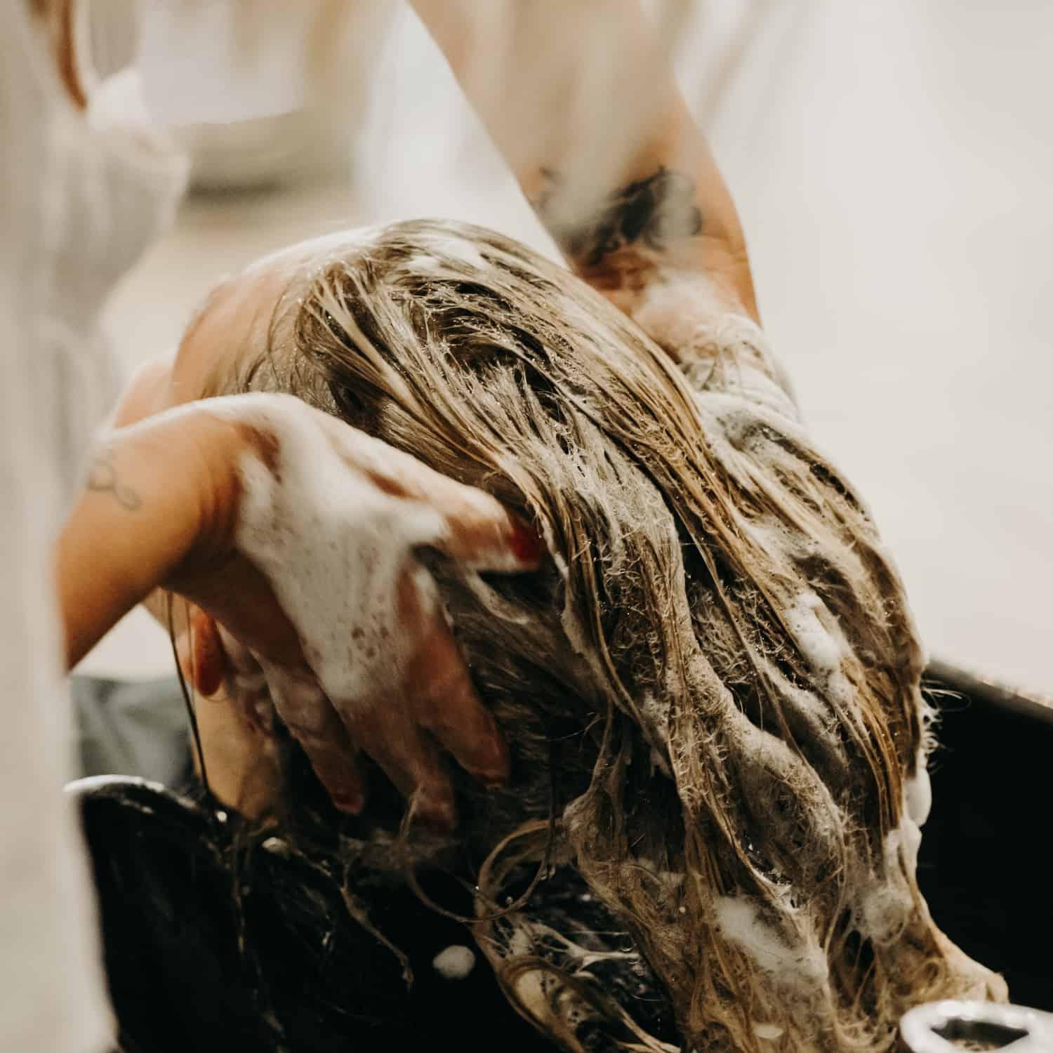 Stylist washing client's hair at Garbo's Salon and Spa